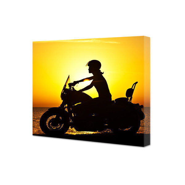 Obraz na płótnie kobieta na motorze o zachodzie słońca